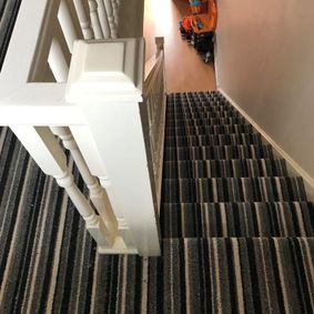 striped carpet on stairs