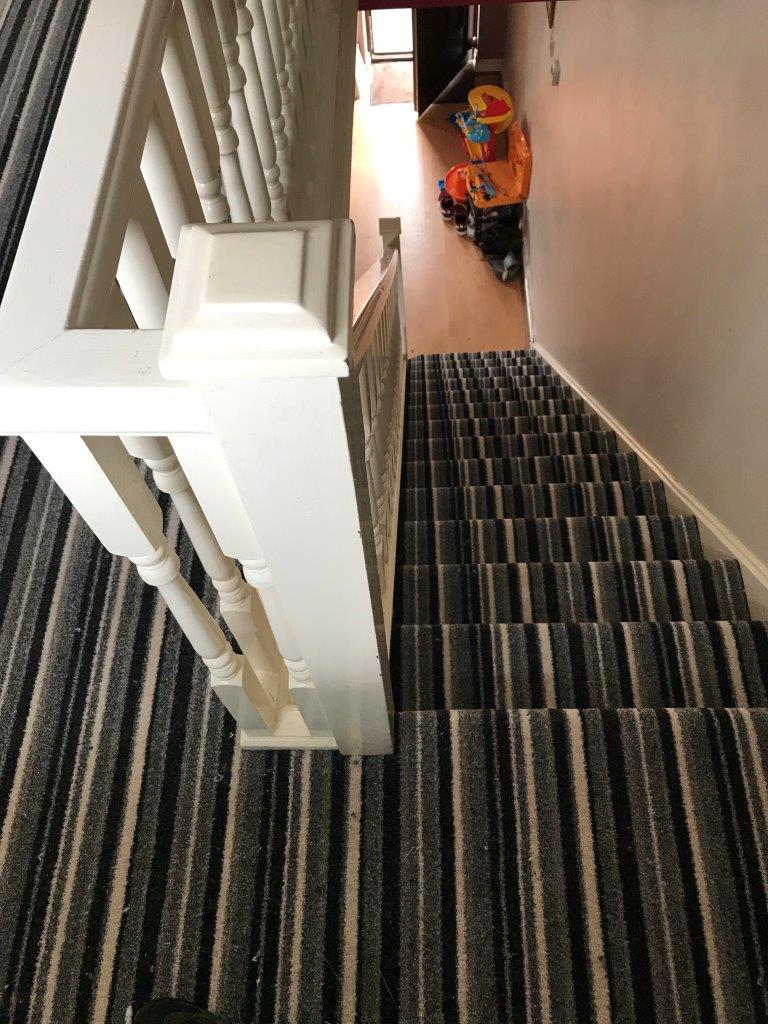 striped carpet on stairs